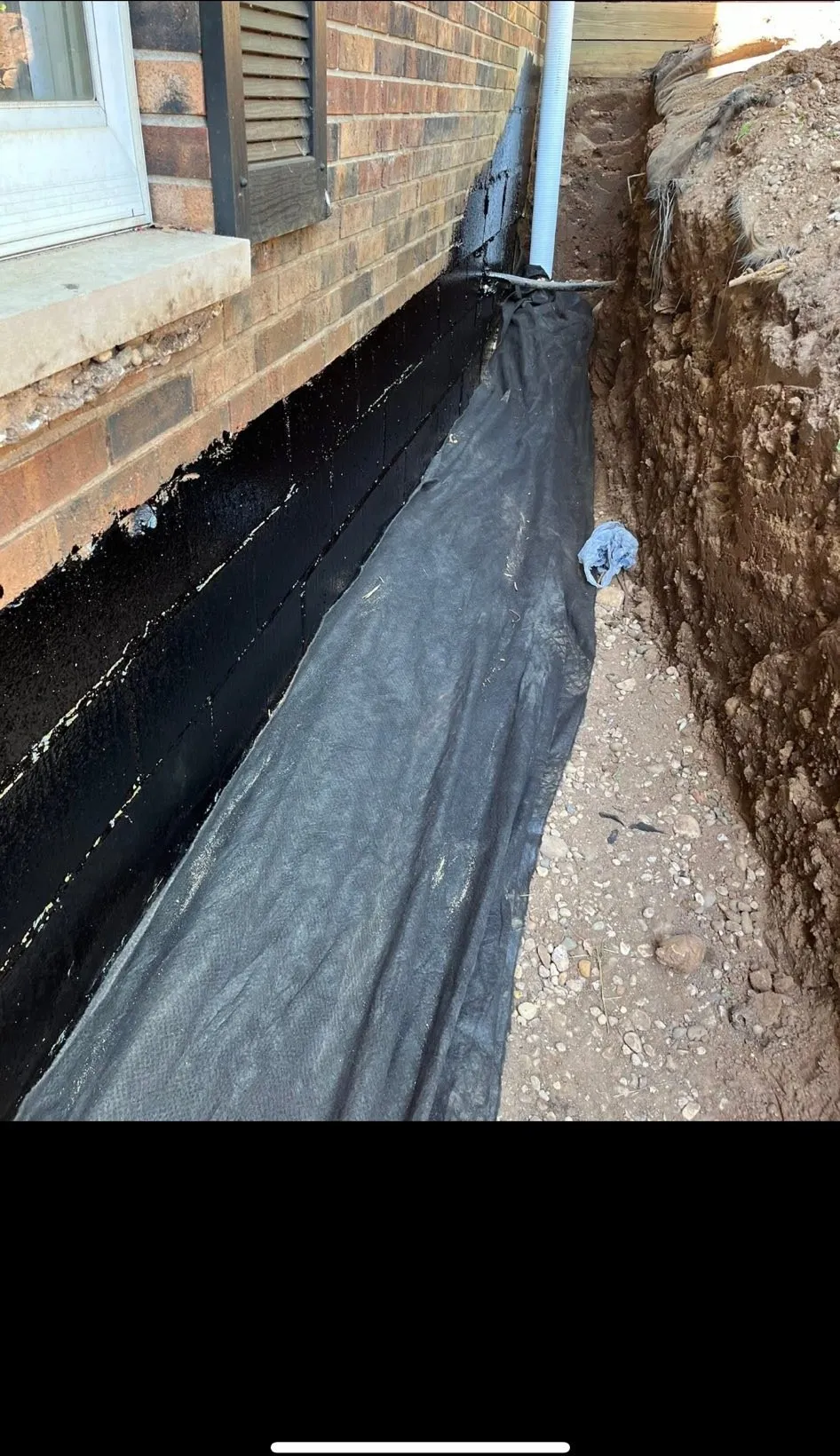 Foundation wall excavated and waterproofed to stop basement leaks