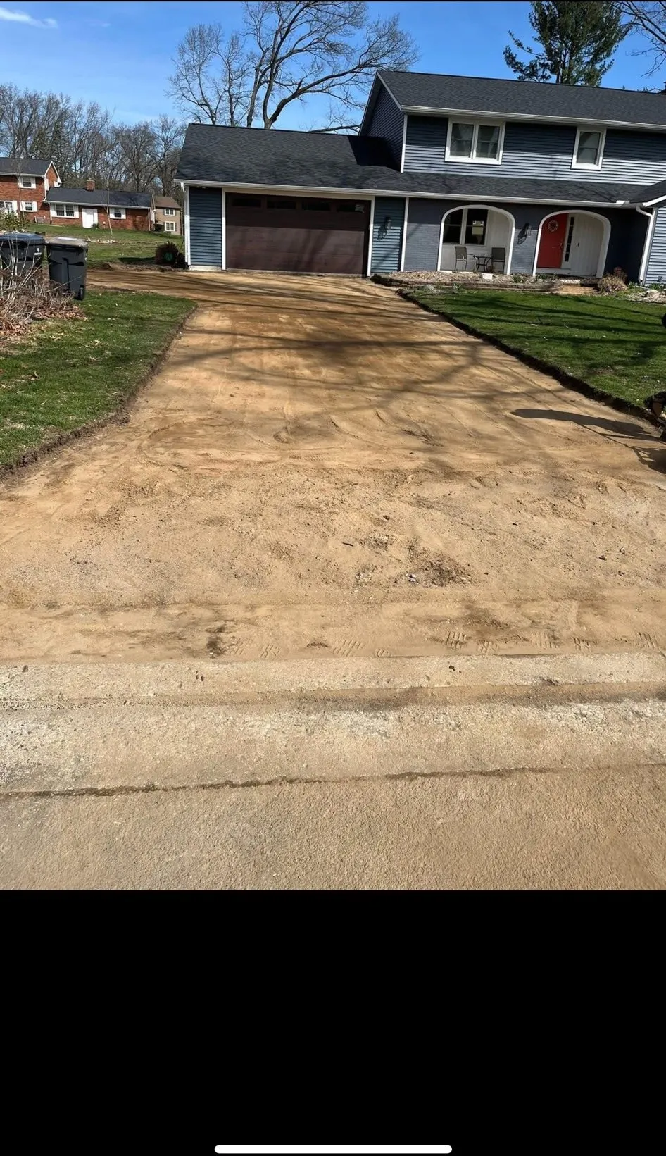 Driveway graded and compacted from the street to the garage, ready for paving
