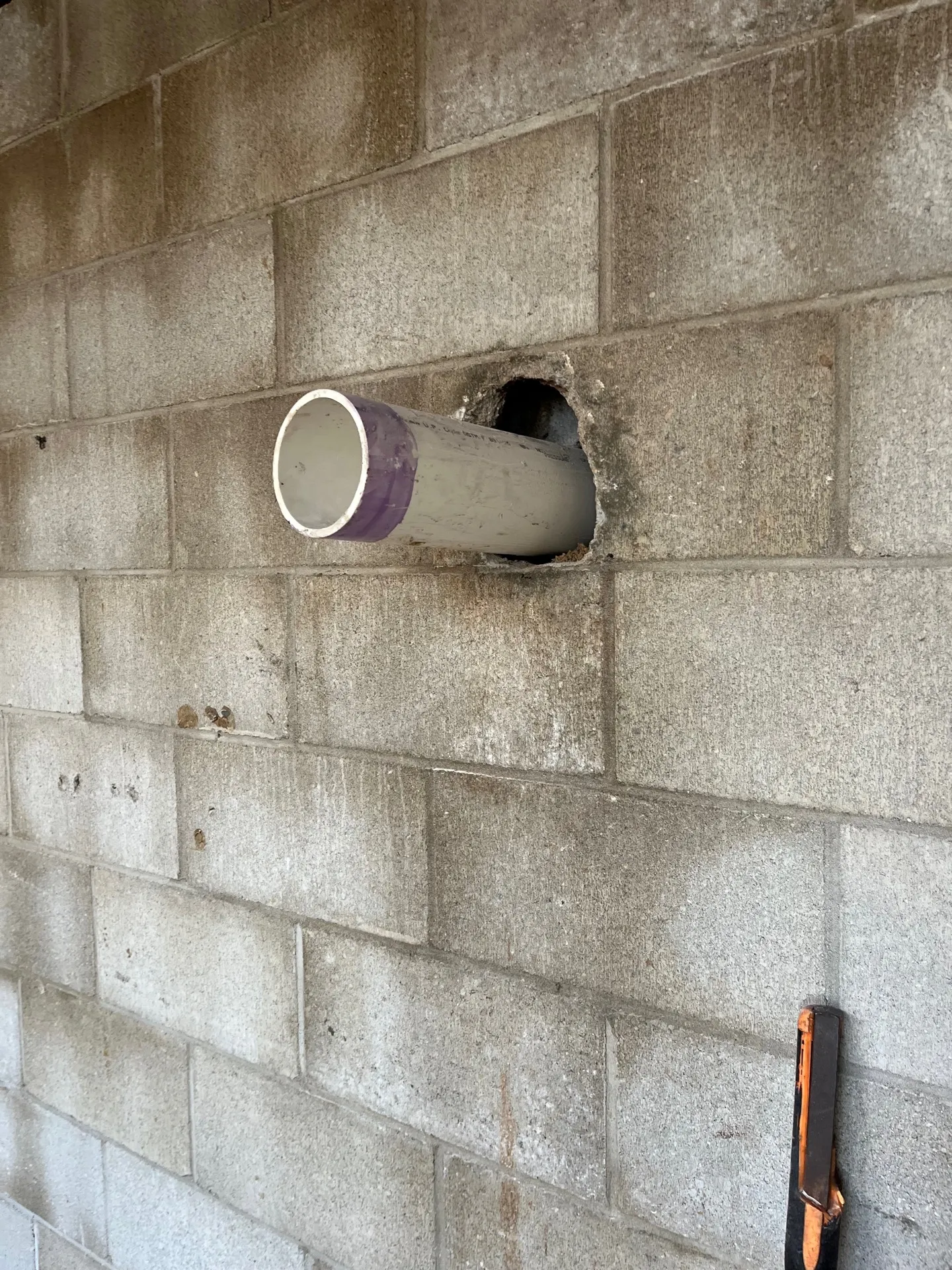 Drain line tied through a waterproofed foundation wall at a Kalamazoo home