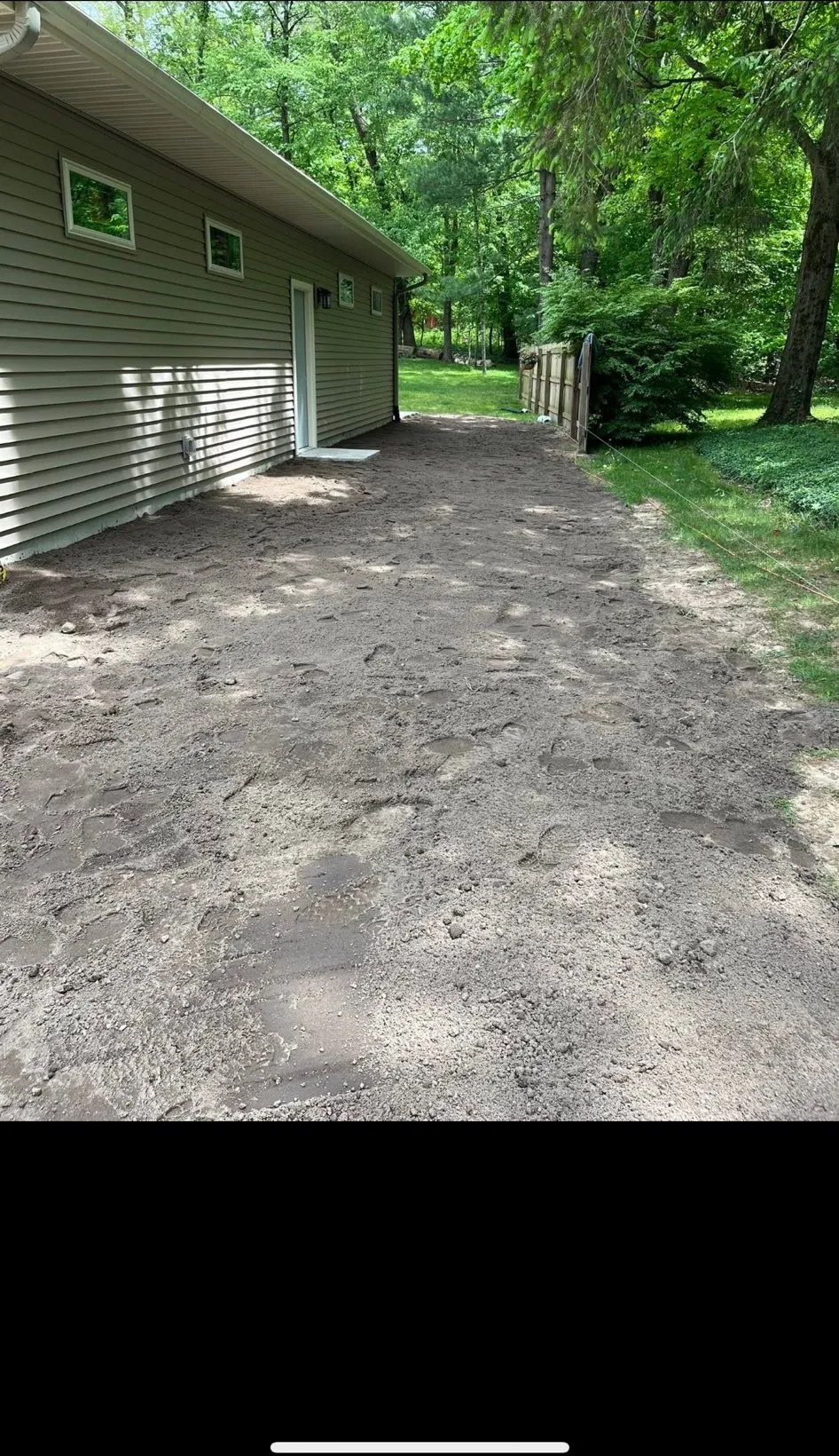 Side yard regraded smooth to carry water away from the house