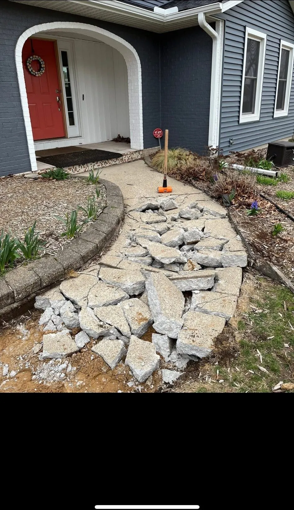 Old front walkway broken out for replacement at a Kalamazoo home
